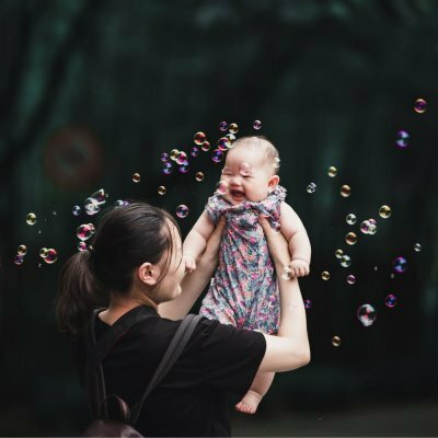 woman playing with baby